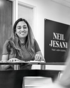 woman-smiling-in-neil-jesani-office-with-logo